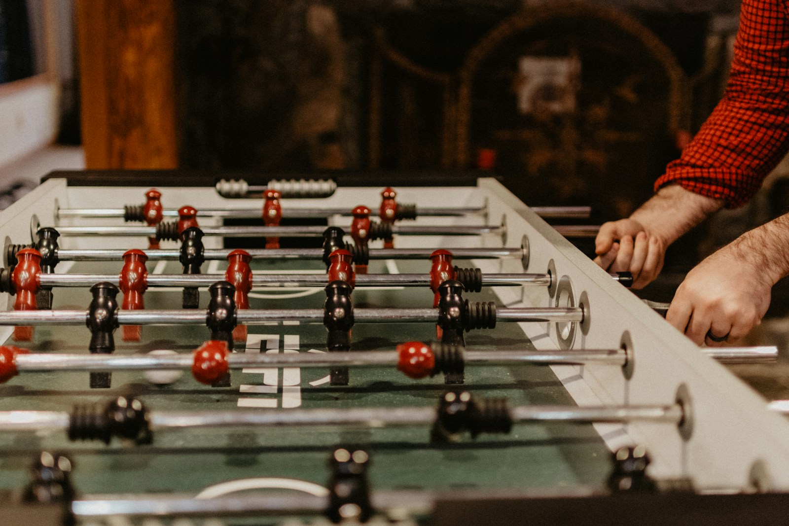 person playing foosball table